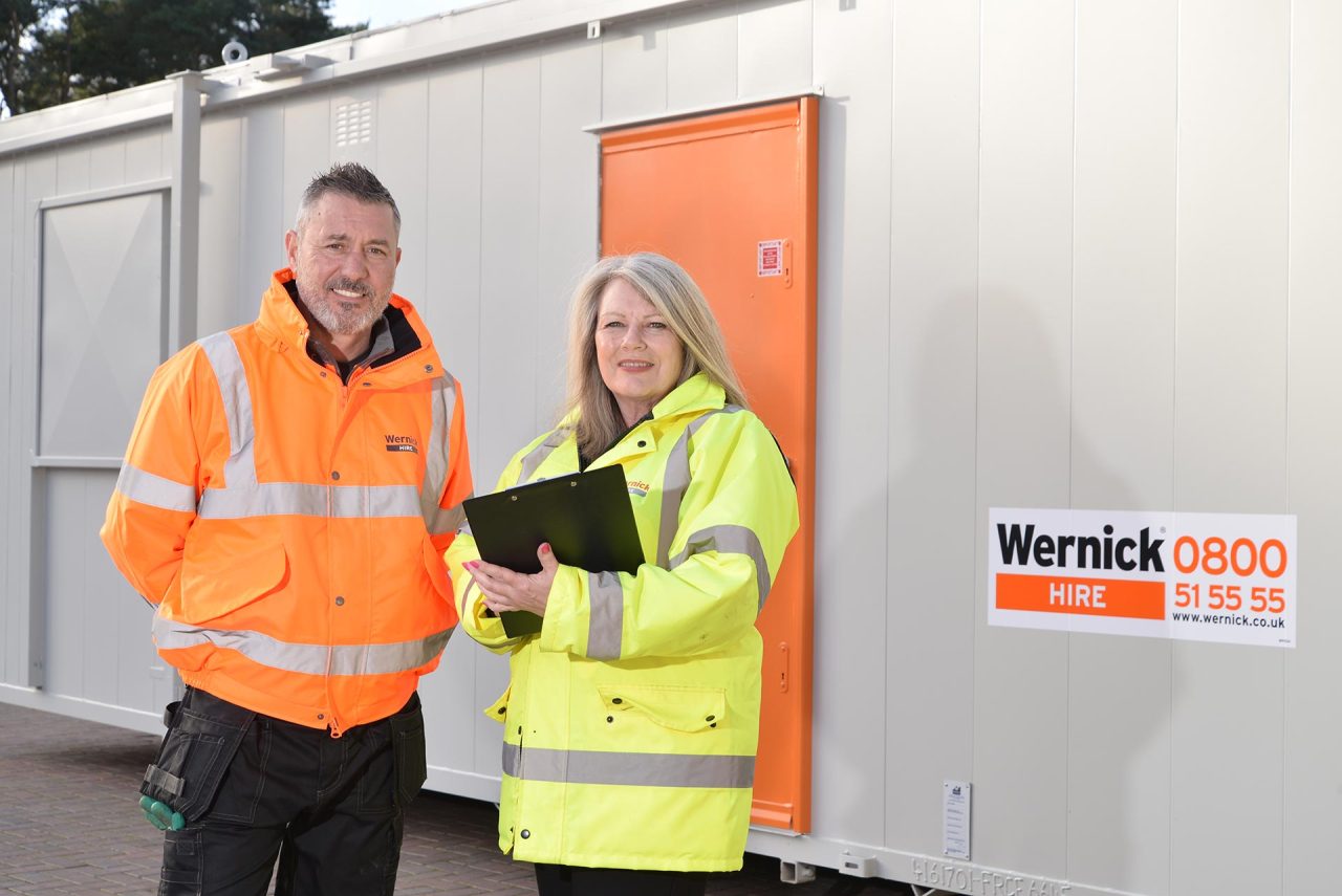 image of two employees outside a cabin