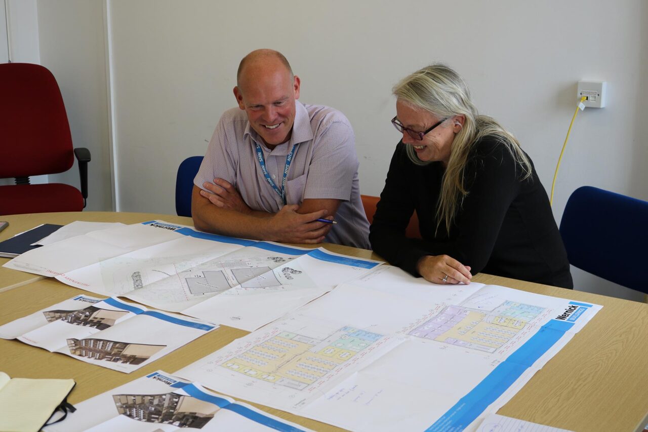 image of two clients looking at drawings