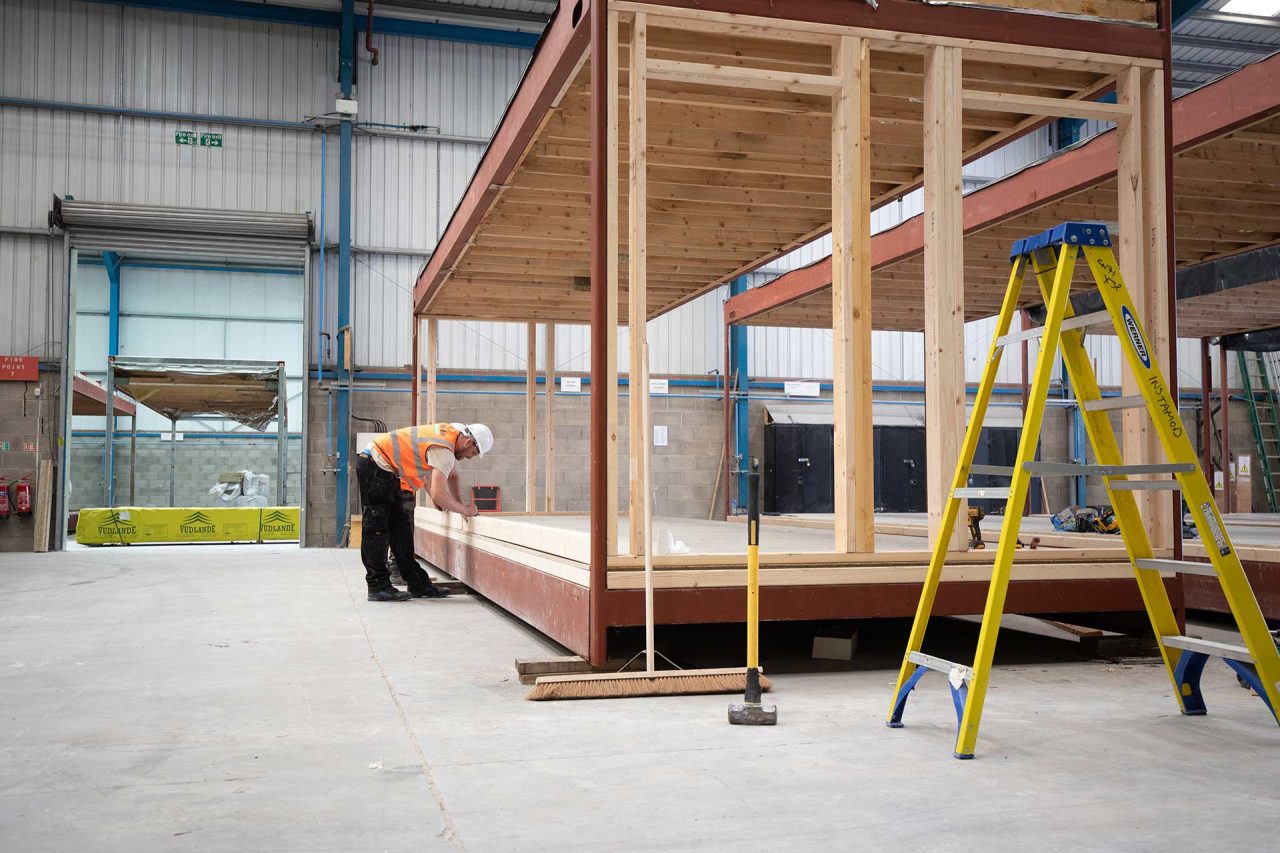 image of worker in the factory refurbishing a modular building