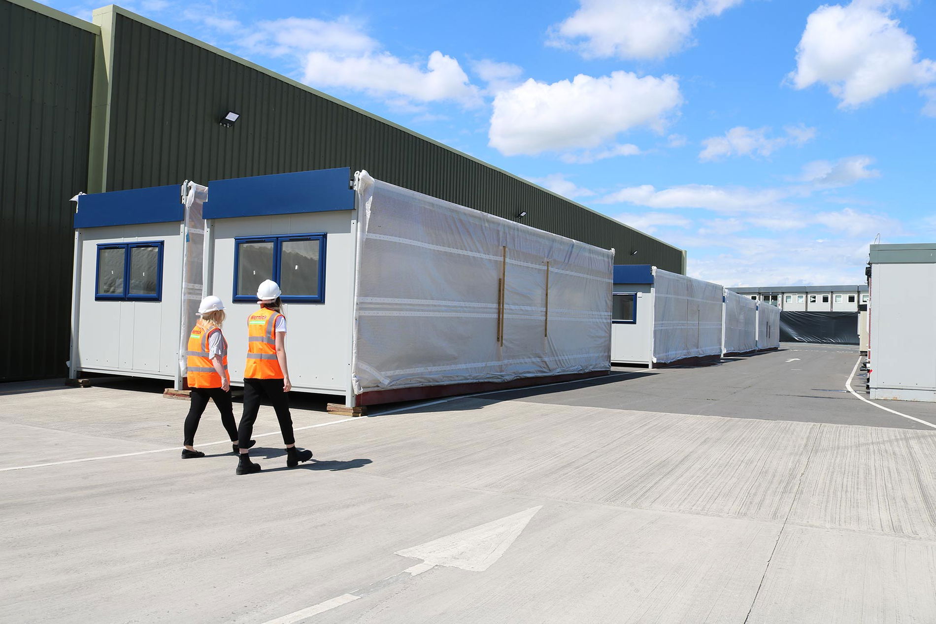 Image of two employees in Wernick Refurbished Buildings yard with modules