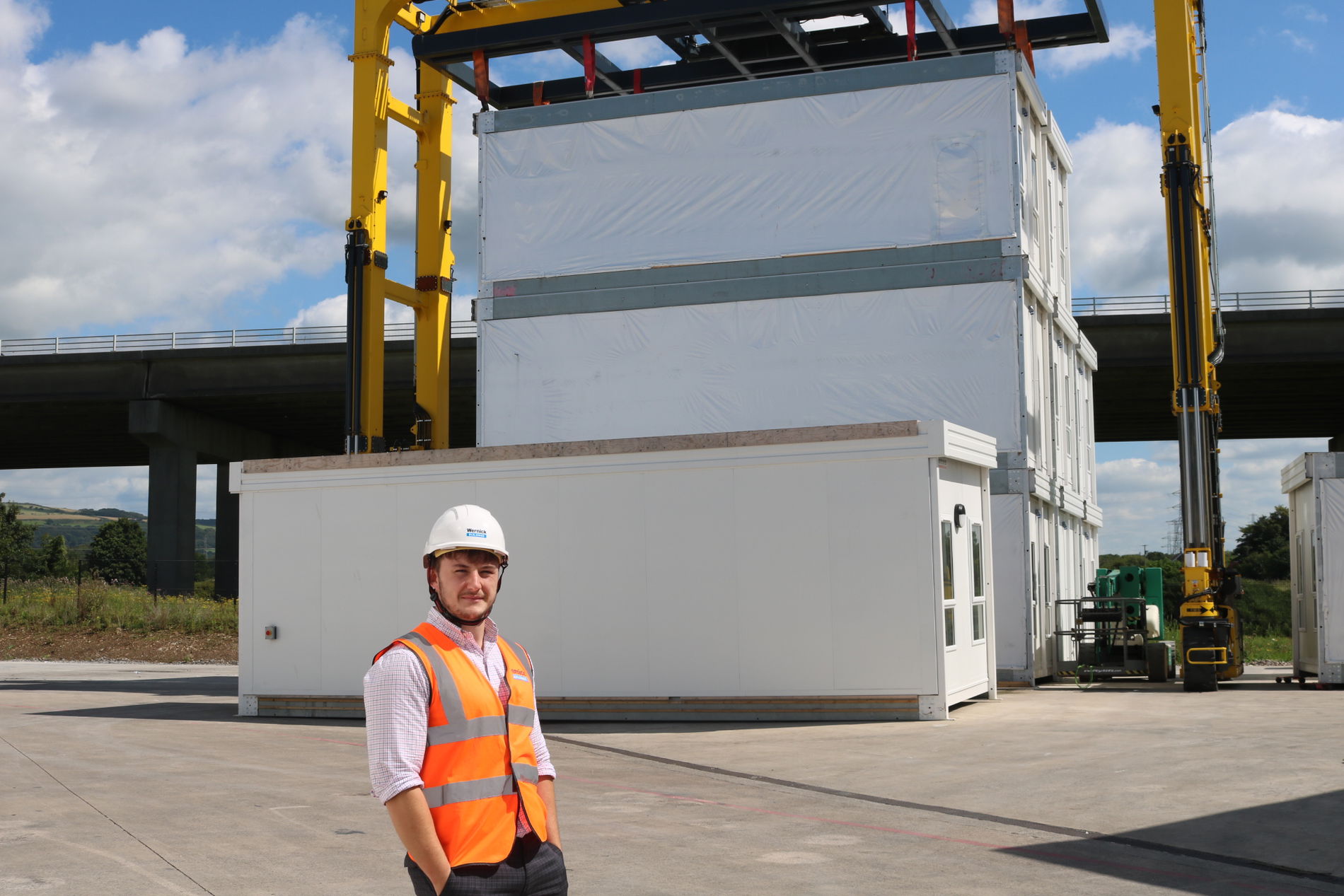 Image of employee infront of crane