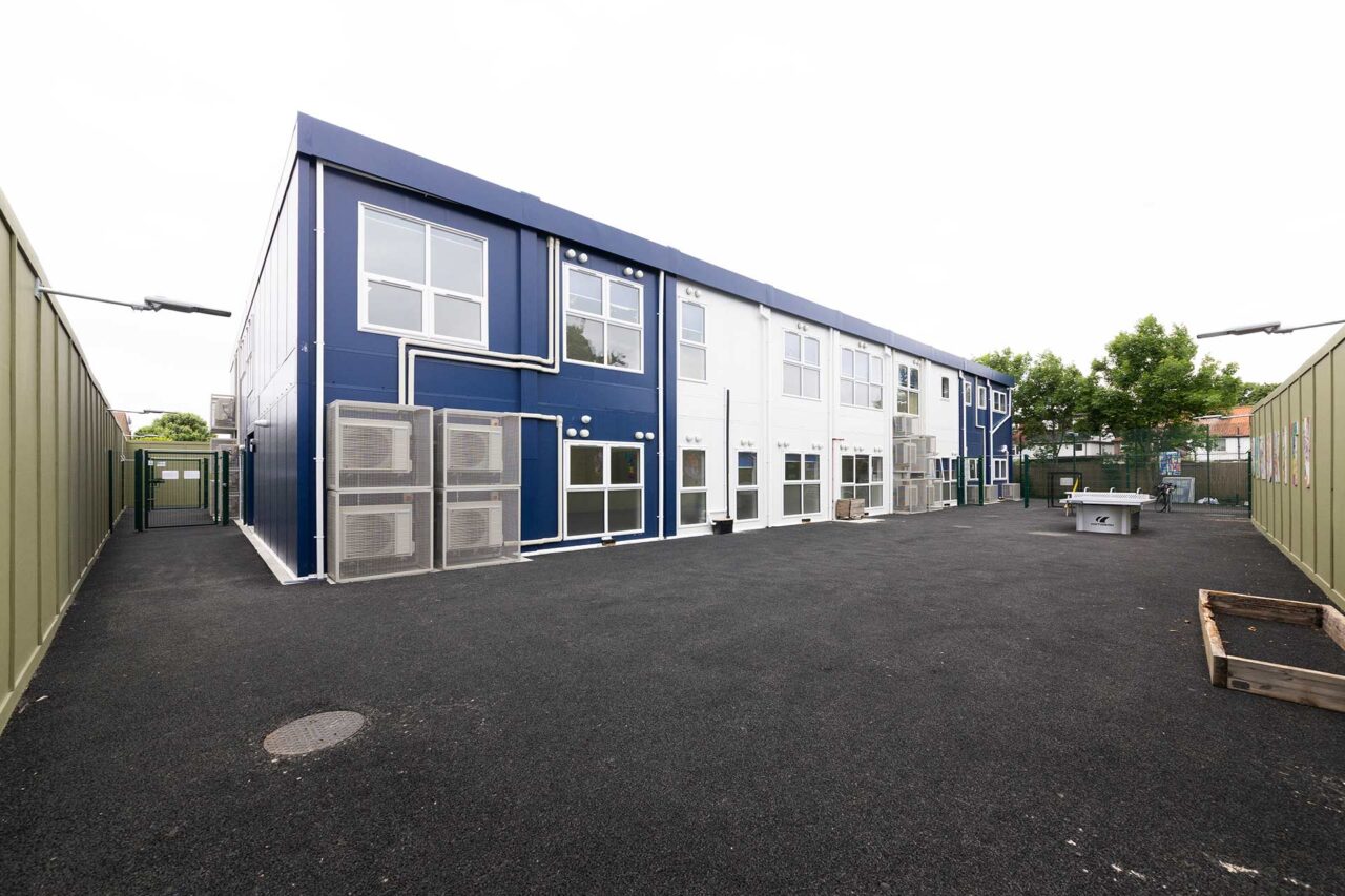 image of a refurbished modular classroom block with blue and white cladding